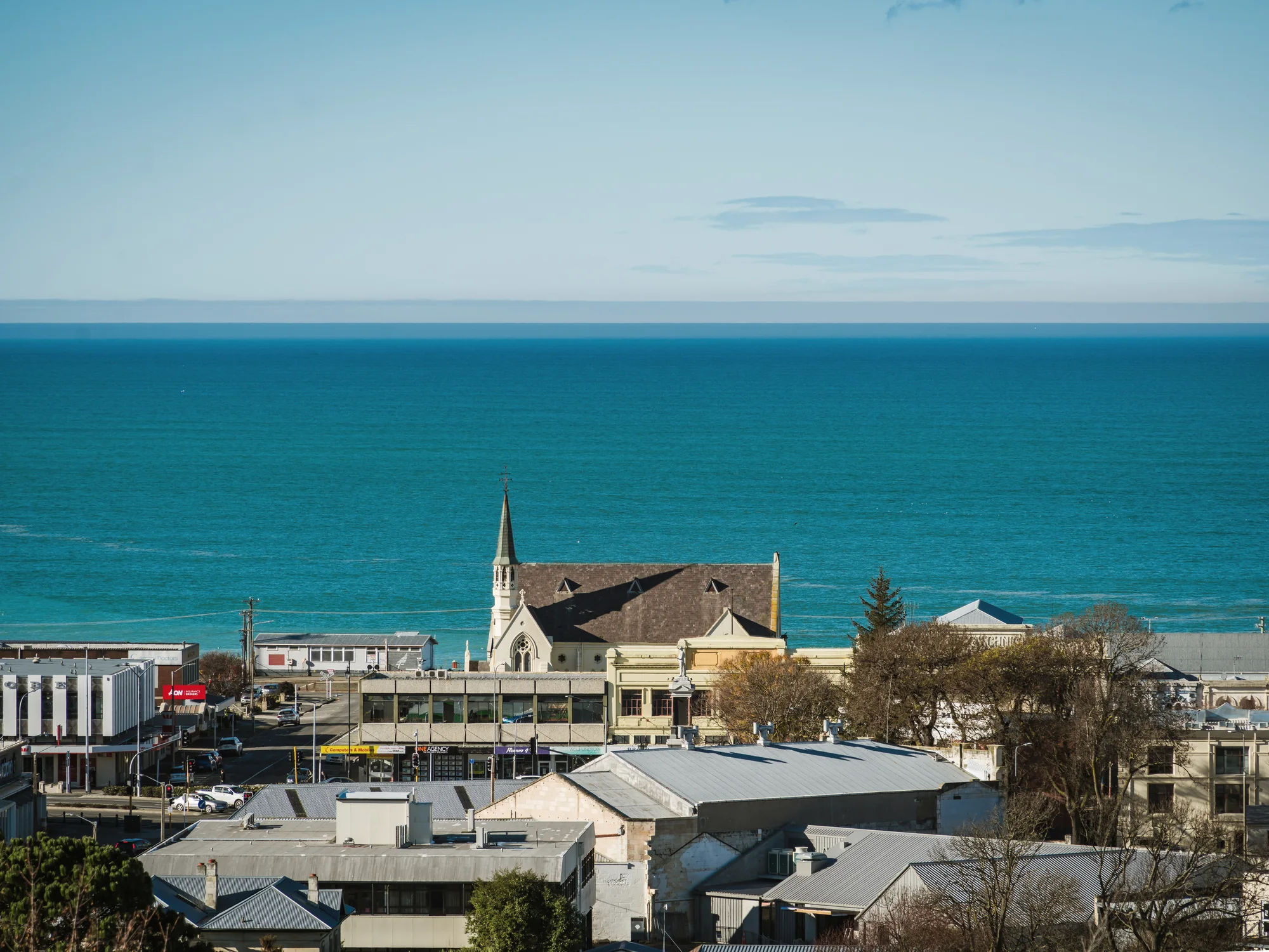 A high Oamaru view over the church and Pacific Ocean.