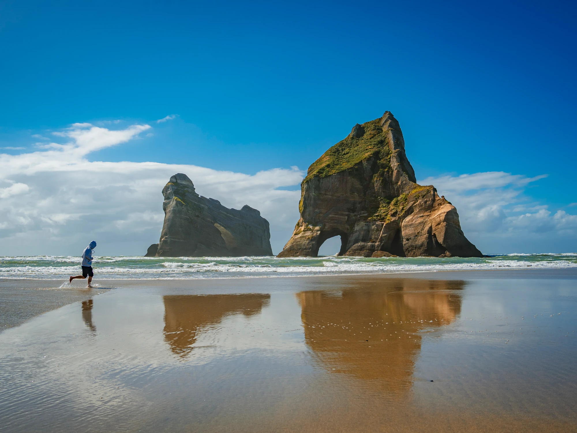Sea stacks and reflections at Wharariki Beach
