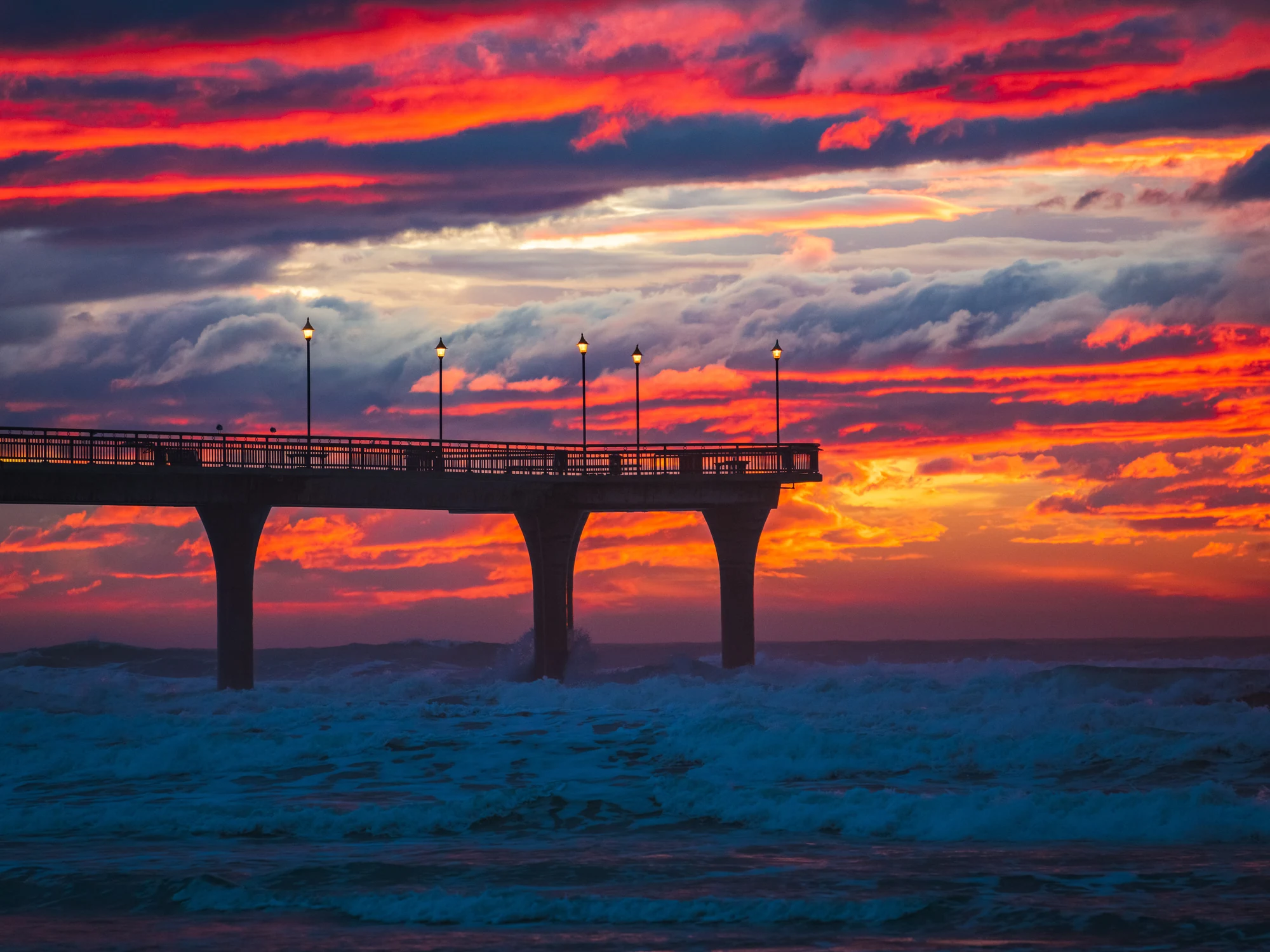 New Brighton Pier, Christchurch, beneath a vivid sunset