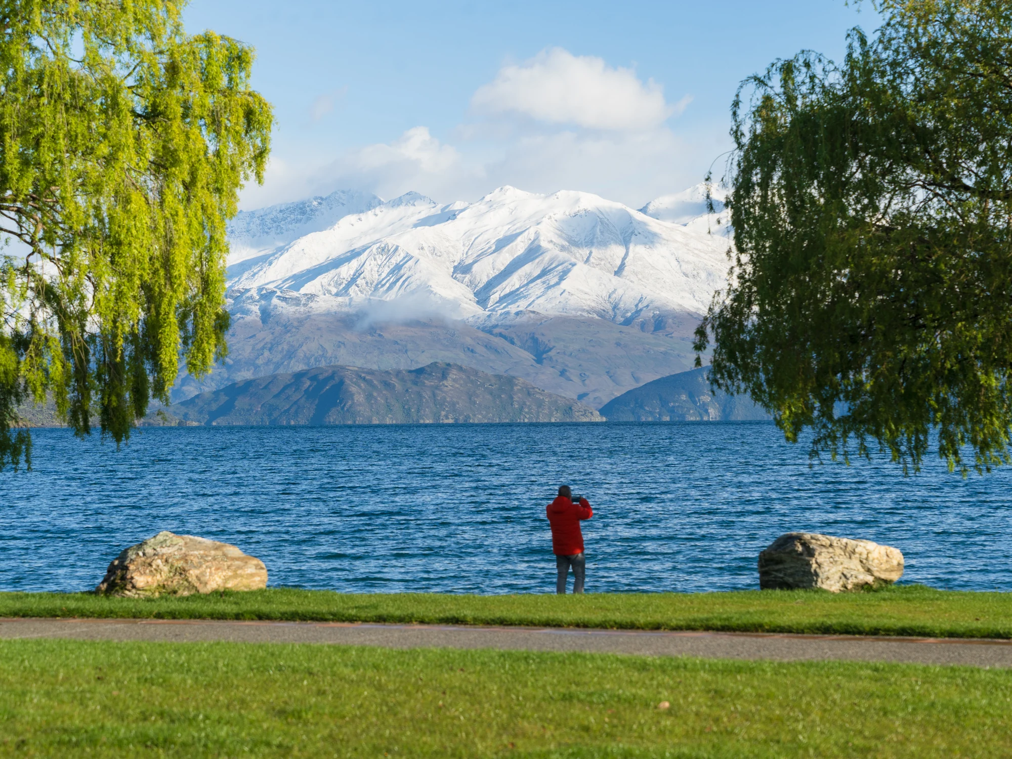 Snowy peaks and a lakeside walker at Wānaka