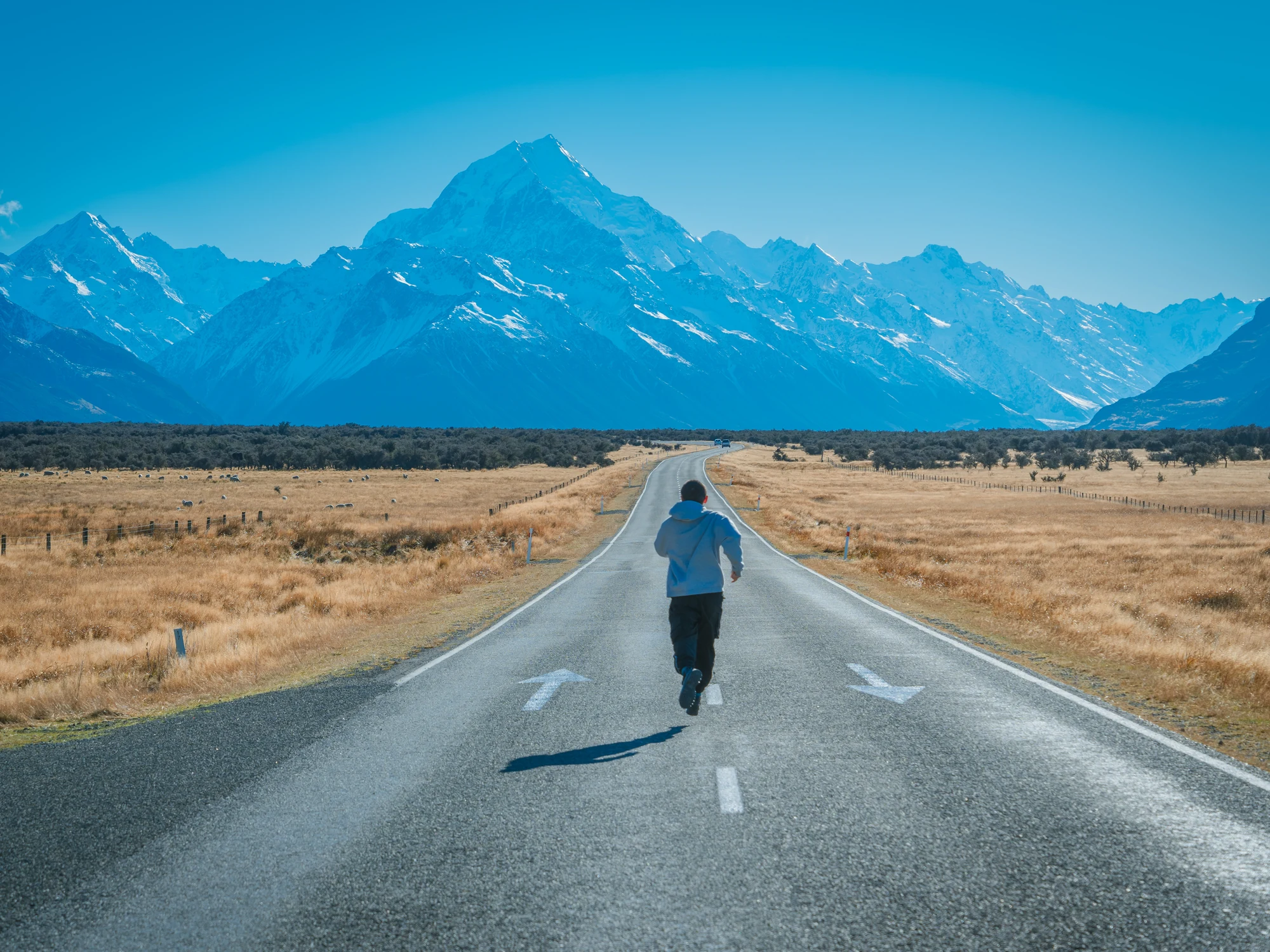 A runner on the road toward Aoraki / Mount Cook