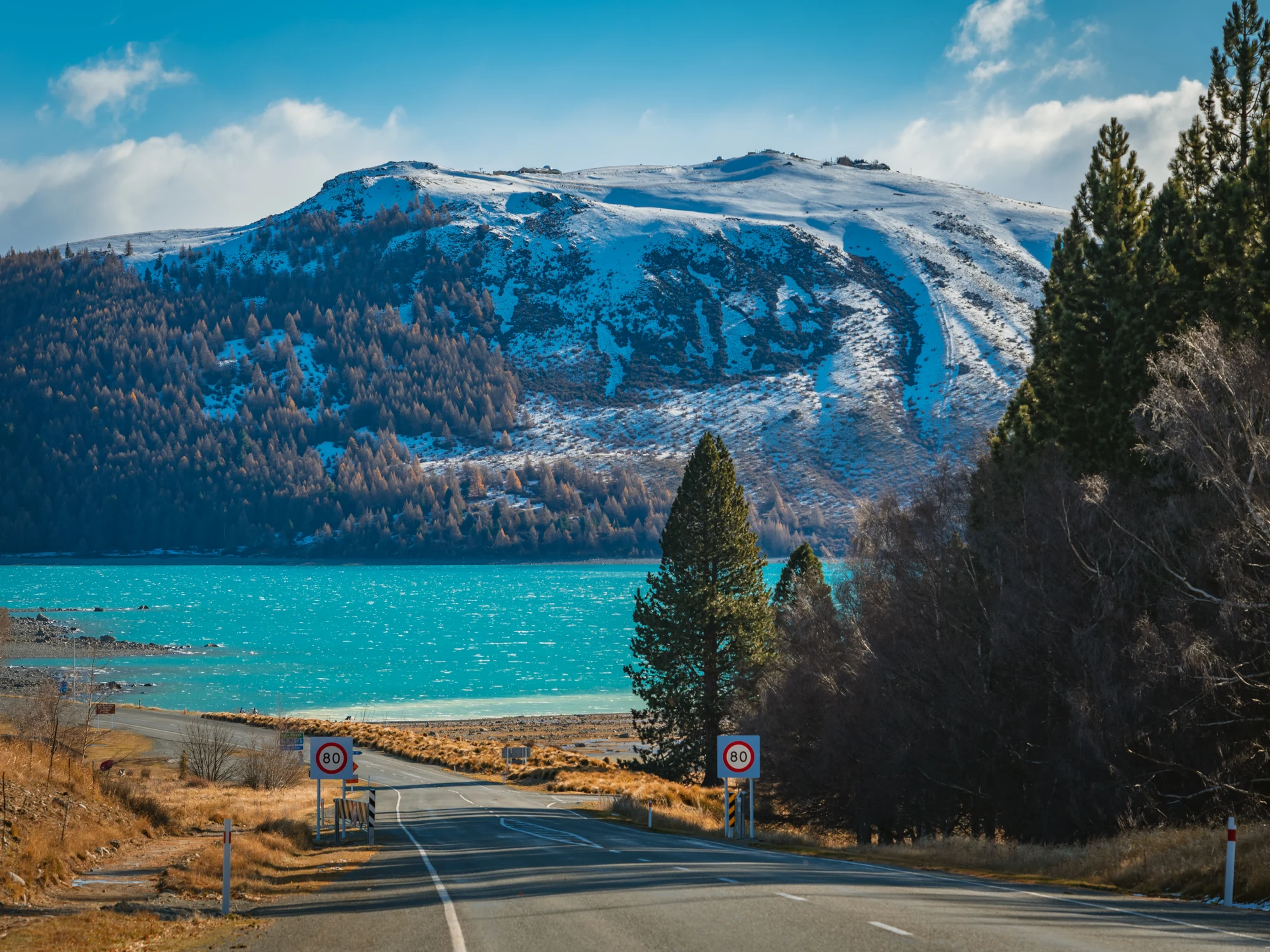 Lake Tekapō and snowy hills from the highway